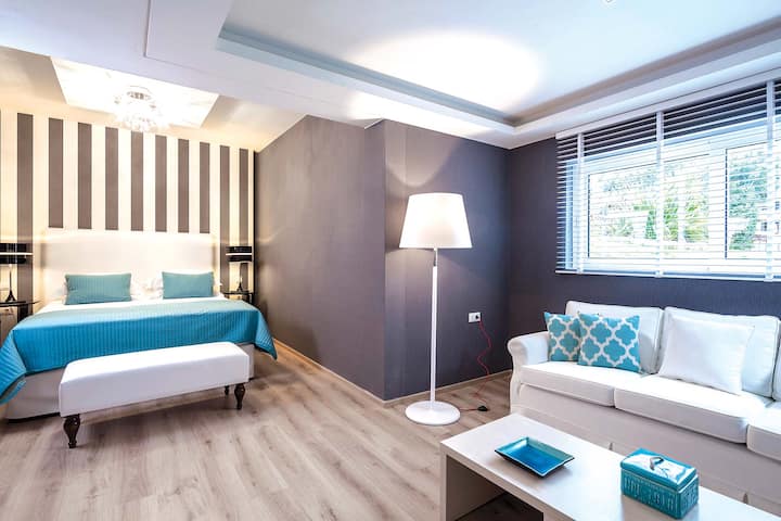Ground Floor: Master bedroom with en-suite, armchairs, garden view, 50” satellite TV