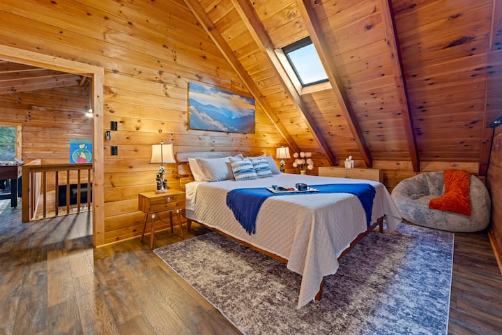 Upstairs bedroom features ample space, natural lighting, and a private balcony