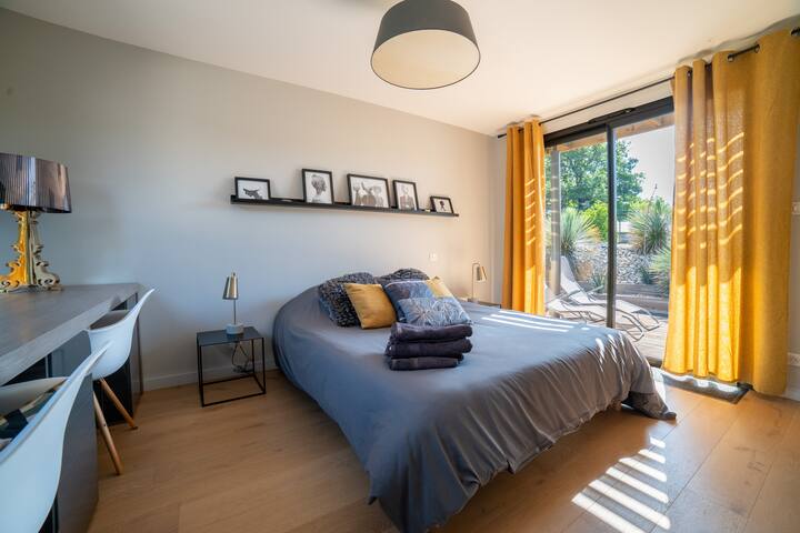 The first master suite offers true independence, while being fully integrated into the house. You will have access to the bedroom, its bathroom and private toilet, a private terrace with deckchairs, a desk and a small fridge.