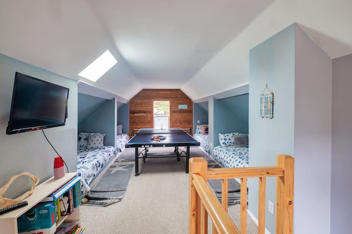 4 double beds, ping pong table, games, puzzles, and TV with a smart DVD player. In the closet are boogie boards and beach chairs.