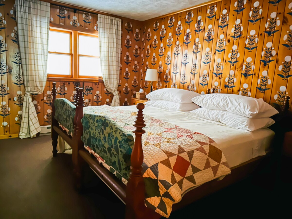 Charming Flower Guest Suite with Indian Flower stenciled walls and two antique twin beds set together as a comfy king. Please see the furniture plan for full bed details. A nostalgic Adirondack retreat filled with character.