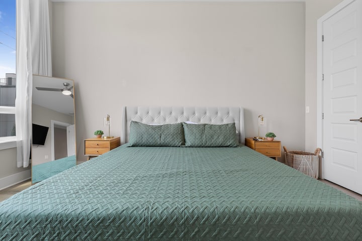 Spacious bedroom with a comfy king bed, natural light, and calming decor—your perfect place to rest and recharge.