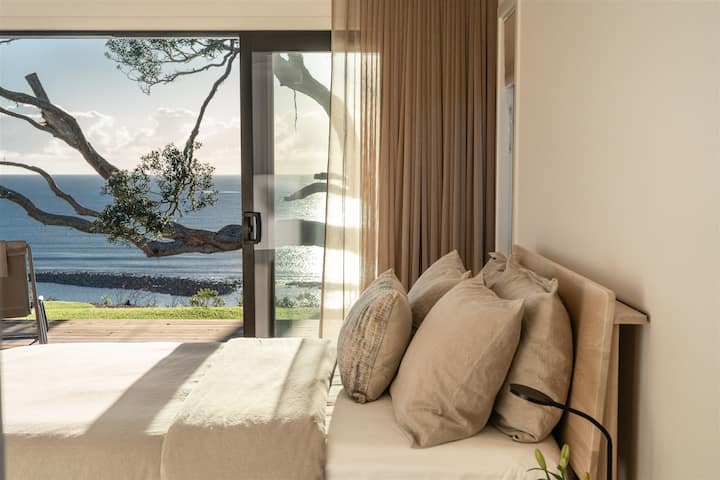 The main bedroom is spacious with a walk-in robe and ensuite bathroom.  Lie in bed in the morning and soak up the sun and sea views.