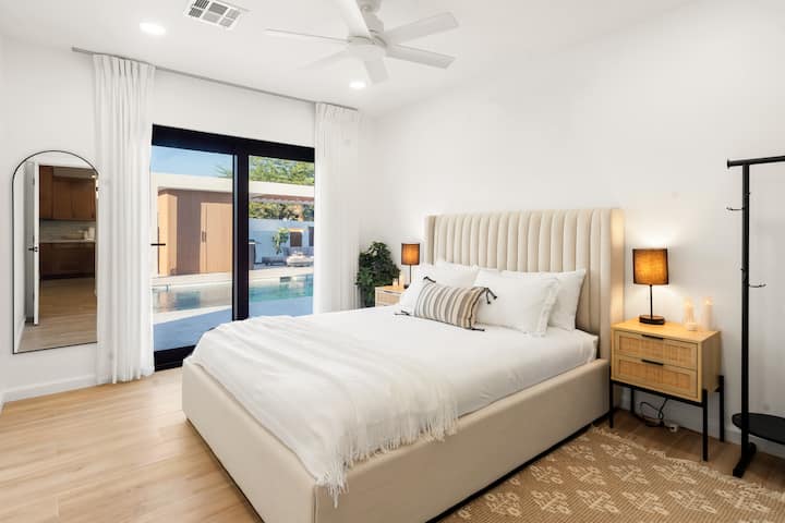 Bedroom with queen bed and walk-out to pool.
