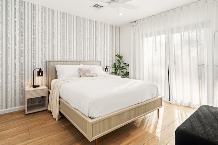 Bedroom with queen bed and walk-out to garden.