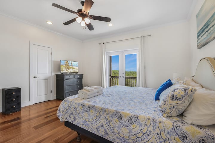 Wake up to peaceful views and soft light in this serene bedroom retreat, perfect for slow mornings and restful nights by the coast.