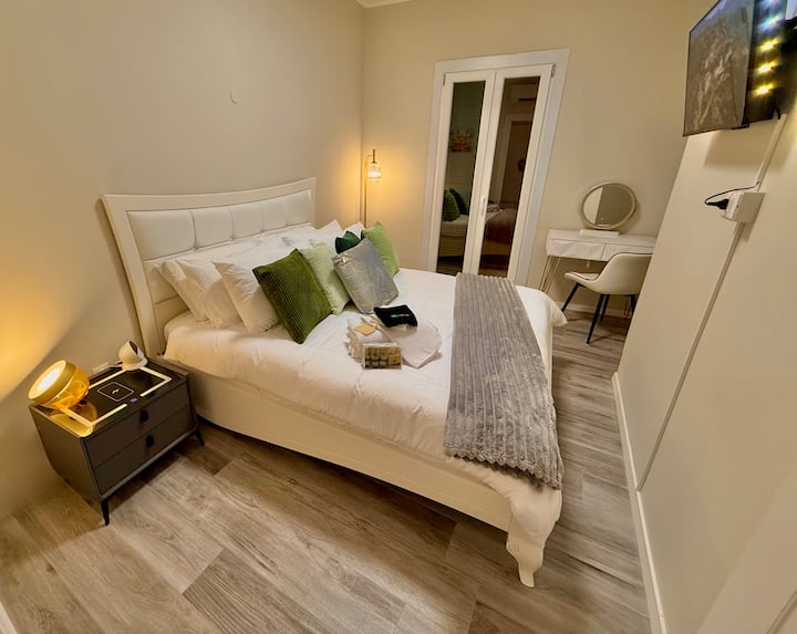 Queensized Bed, assortment of sleeping pillows, wireless and wired charging station nightstands. Smart speaker assistant, Hue lighting and smart TV. 