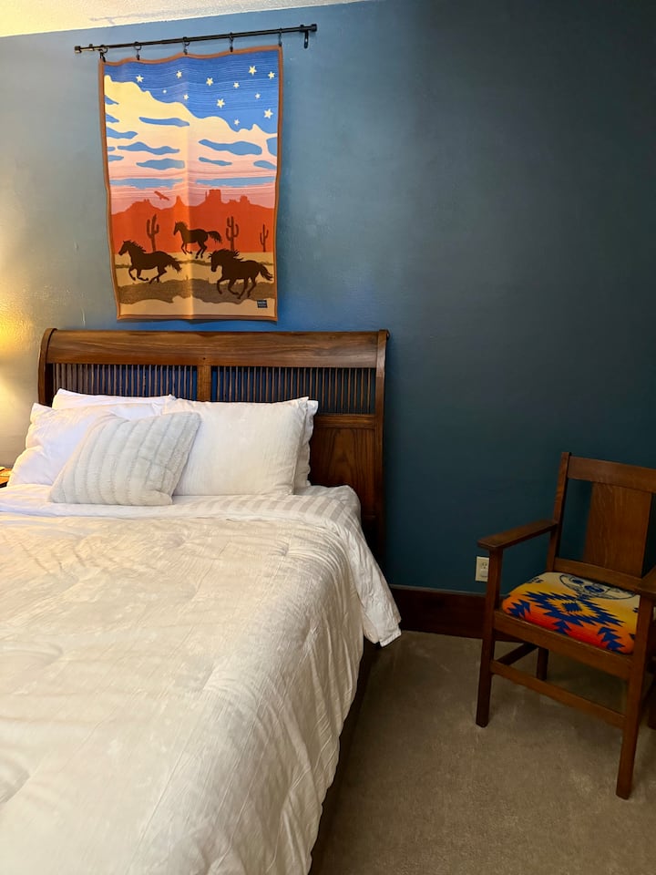 Suite 1 front bedroom with queen bed.