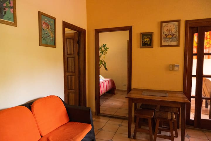 A small inside sitting area with additional seating outside in the screened in terrace area.