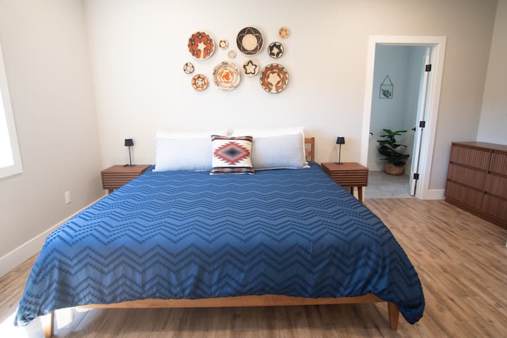 Main bedroom upstairs with king size bed and en-suite bathroom. Large closet and storage options.