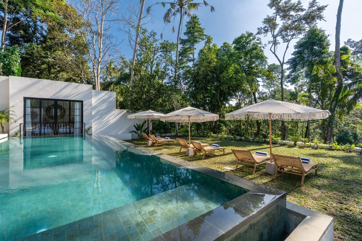 The garden and deck at Fire Fly Bali Villa