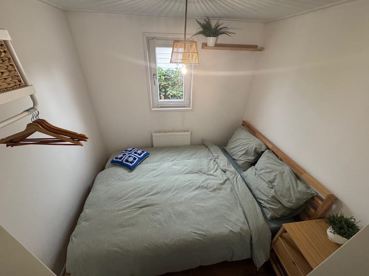 Double bed with nightstand and coat rack