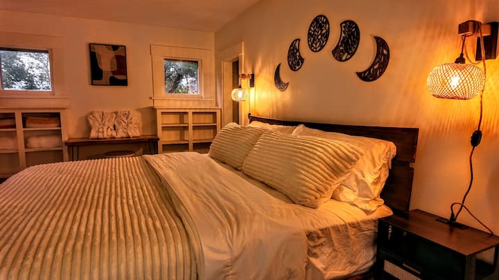 Cozy sconces and nighstand, each with charging stations