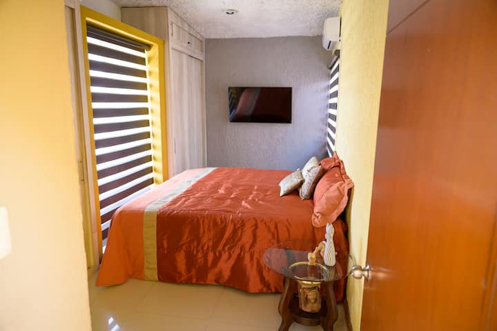 ✨Recámara principal✨ Esta acogedora habitación cuenta con una cama tamaño king, televisión de pantalla plana y aire acondicionado. Las ventanas con persianas dobles permiten regular la luz a tu gusto, creando un ambiente ideal para el descanso.