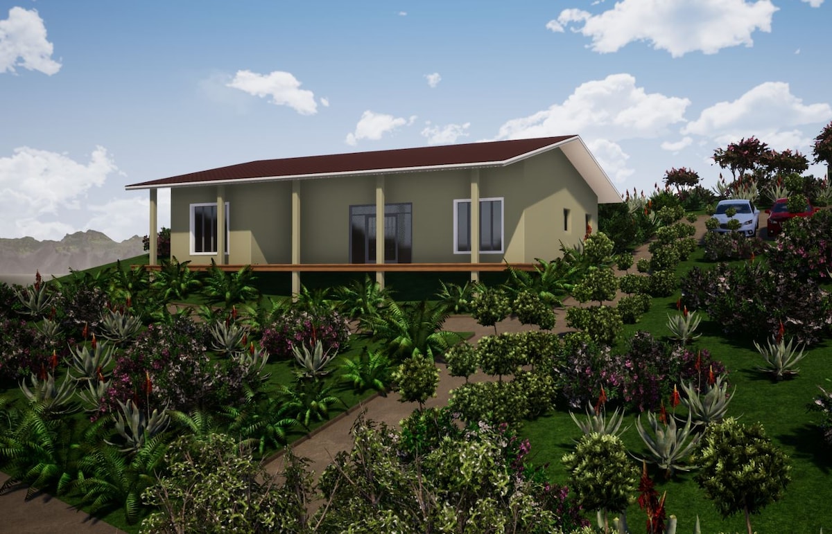 The eco-lodge is situated amid lush greenery, featuring a modern design with large windows. A covered porch extends along the front, allowing for outdoor relaxation. Pathways lead through colorful plants, enhancing the natural surroundings while a vehicle is parked nearby.