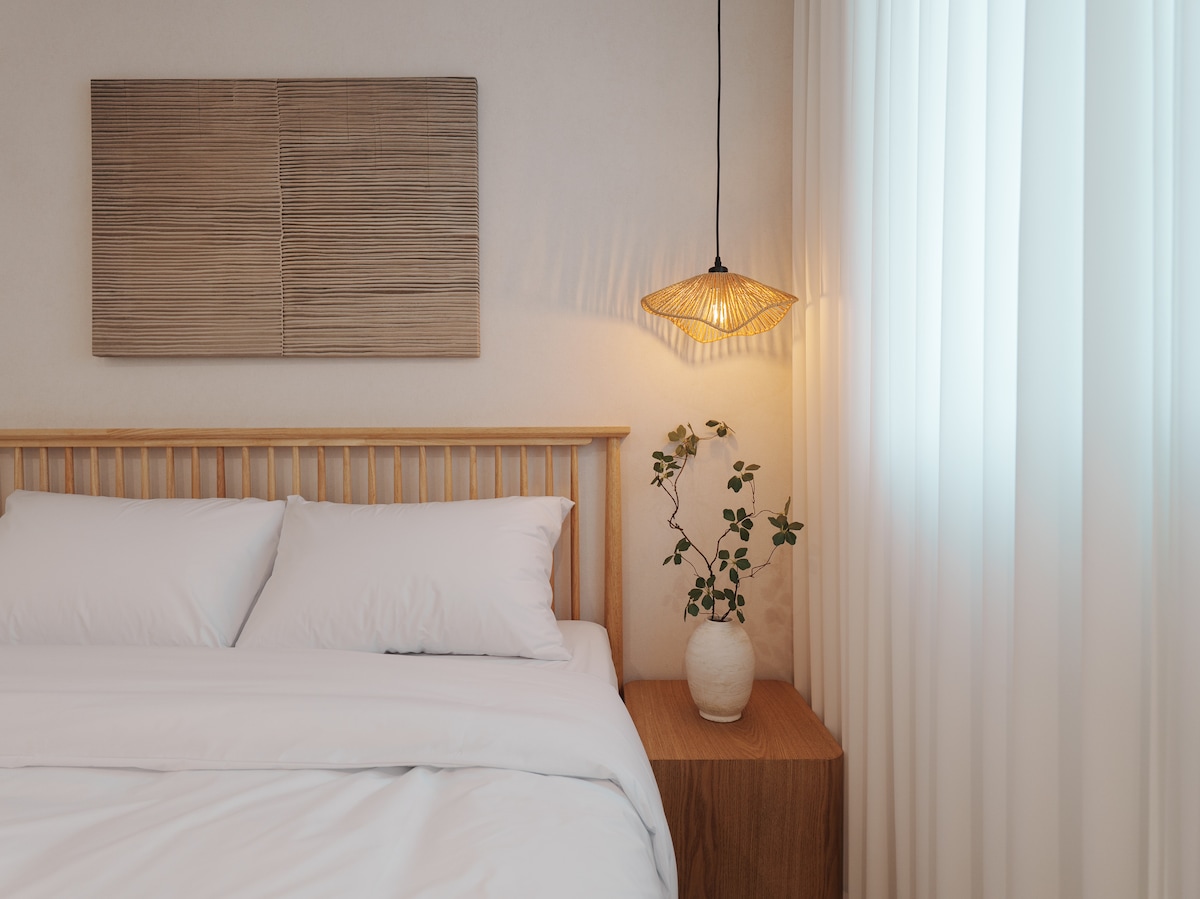 Voici la chambre 3, avec un grand miroir, la climatisation et de la literie de style hôtelier pour un séjour confortable.