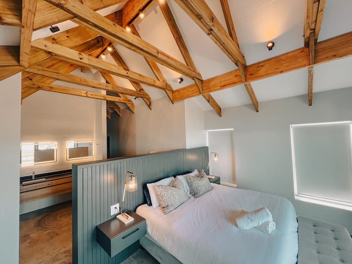 Kitanda cha Kifahari cha Super King chenye mandhari ya kuvutia ya bahari na mlango wa kuteleza kwenye sitaha ya kujitegemea.