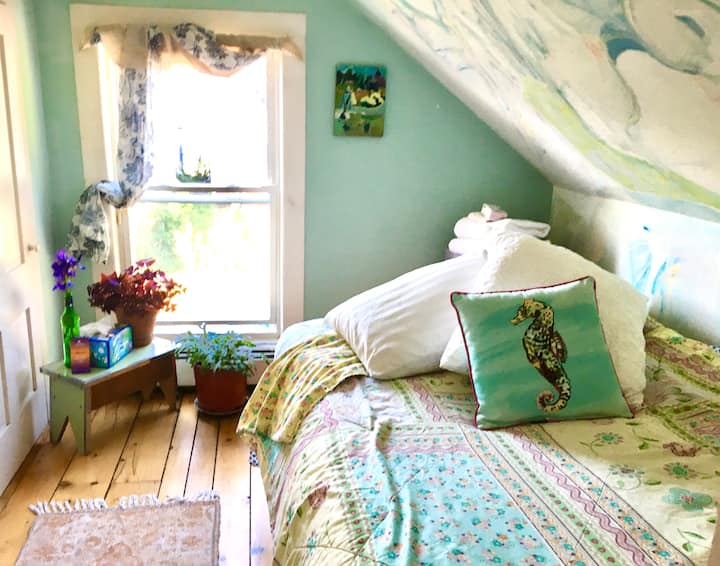 This petit magic bedroom has a double futon on frame, hand painted wall murals and wonderful southern light. Original wood floors and slanted low ceiling create a cozy nest. Best for those under 6’ in this petit bedroom that measures 8 x 10 ft.