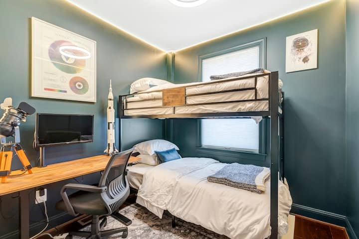 Twin-over-twin bunks plus a dedicated desk: the flex room that works for kids, teens, or the one person who has to hop on a call mid-vacation.