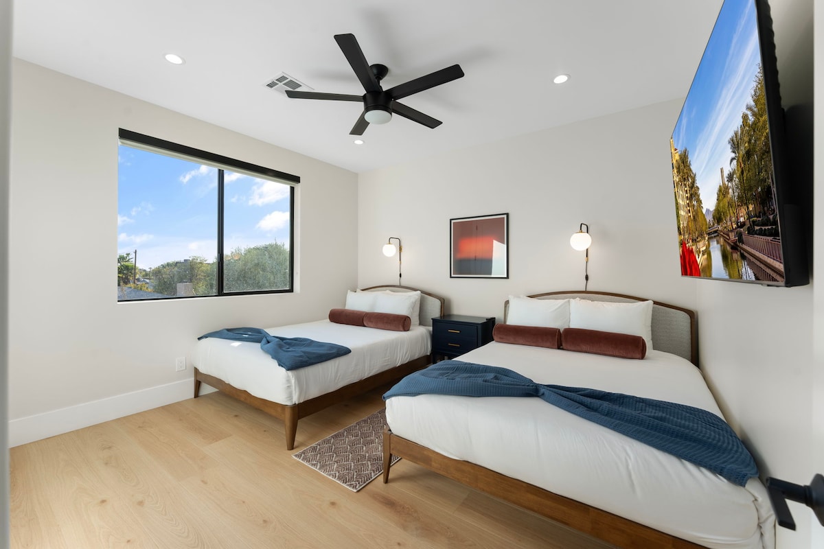 Bedroom Three features two full-size beds with cozy linens, perfect for families or friends traveling together.