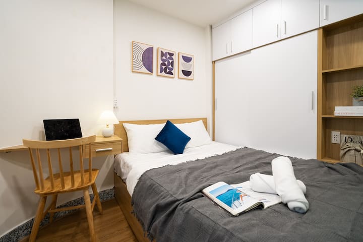 Chambre avec un lit Queen Size, un espace de travail dédié et du linge de lit en coton haut de gamme pour un séjour confortable.