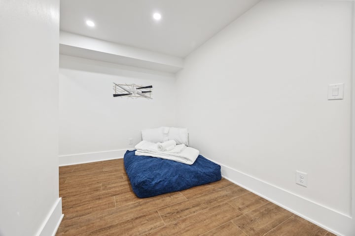 The floor mattress can be pulled into the game room for privacy, but otherwise it's in an open area of the home. 