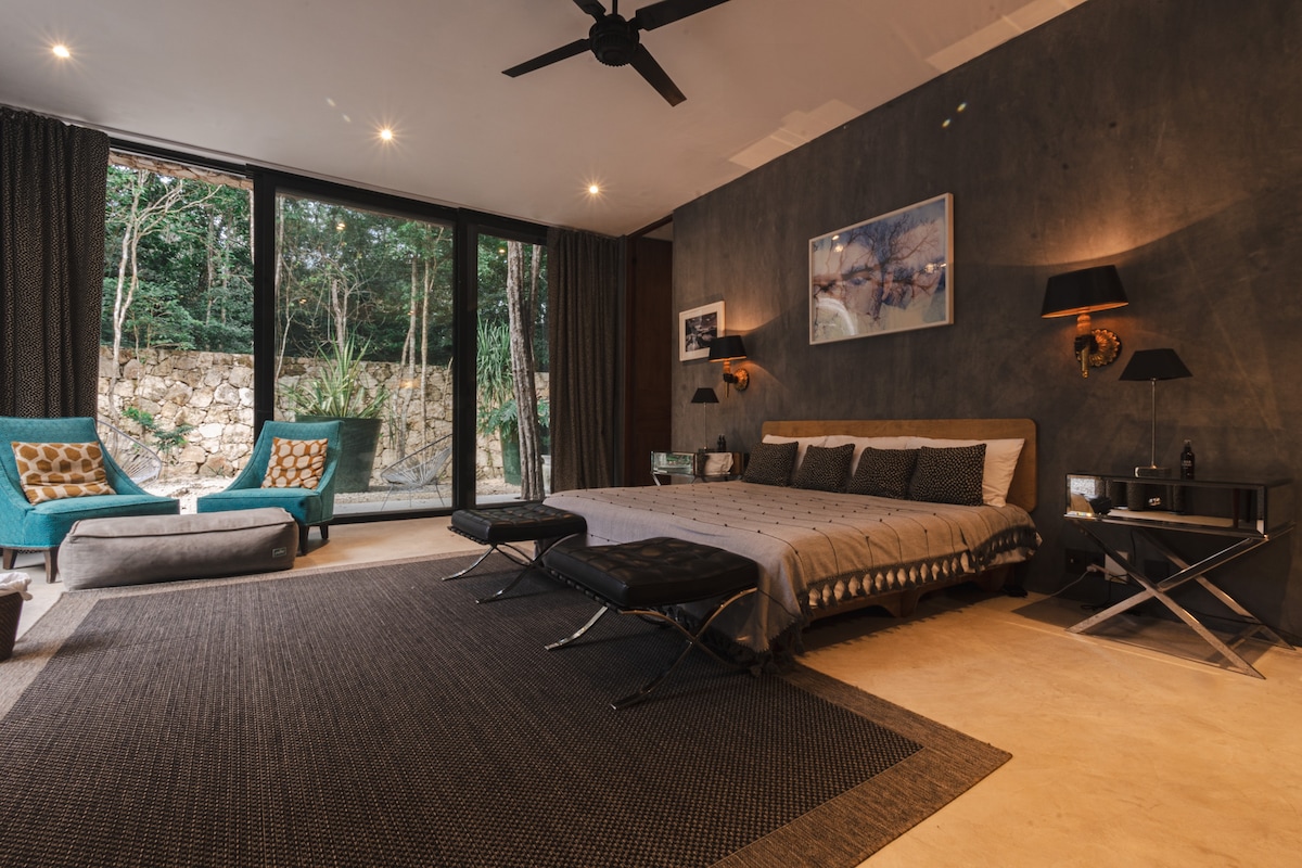 Evenings take on a softer rhythm in this moody, refined suite. With warm lighting, serene jungle views, and layered comfort, it’s the perfect setting for quiet evenings and restful sleep.