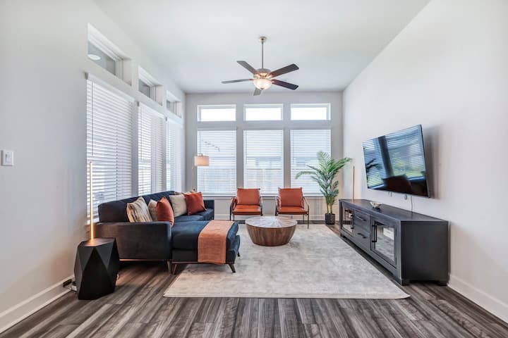 Spacious living room with seating for 5.  50 inch Smart TV, and a Air purifer!  You will love the tall ceiling in our home, and the large windows