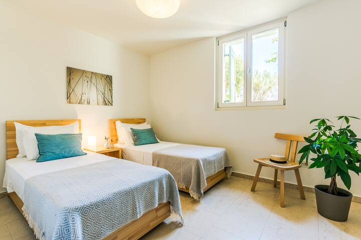 Lower Level: Bedroom 6 with twin beds, en-suite bathroom and direct access to the terrace