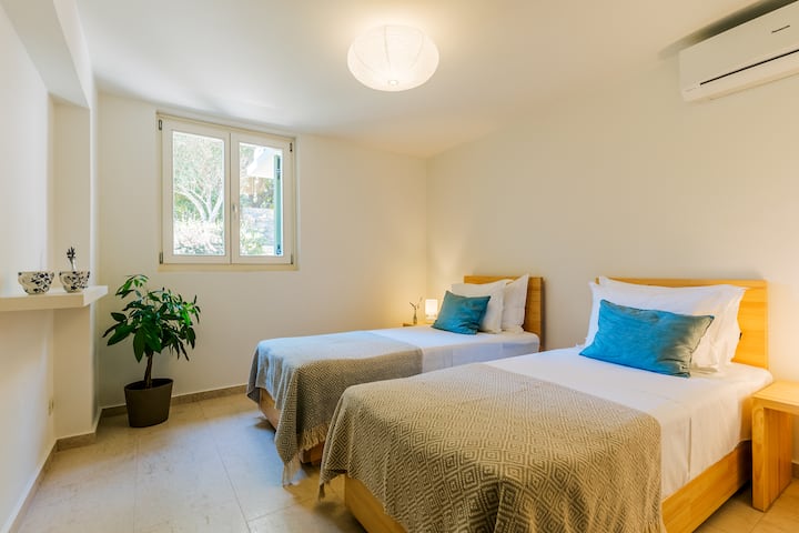 Lower Level: Bedroom 8 with twin beds, en-suite bathroom and direct access to the terrace