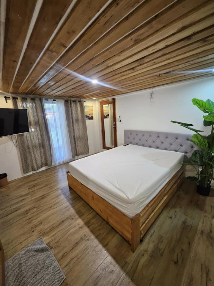 El dormitorio de la casa de la caja cuenta con una cómoda cama tamaño queen con un sofá cama, ¡perfecto para los niños! Disfruta de tu propio baño privado para mayor comodidad y conveniencia. Un espacio acogedor diseñado para noches tranquilas y mañanas relajadas.