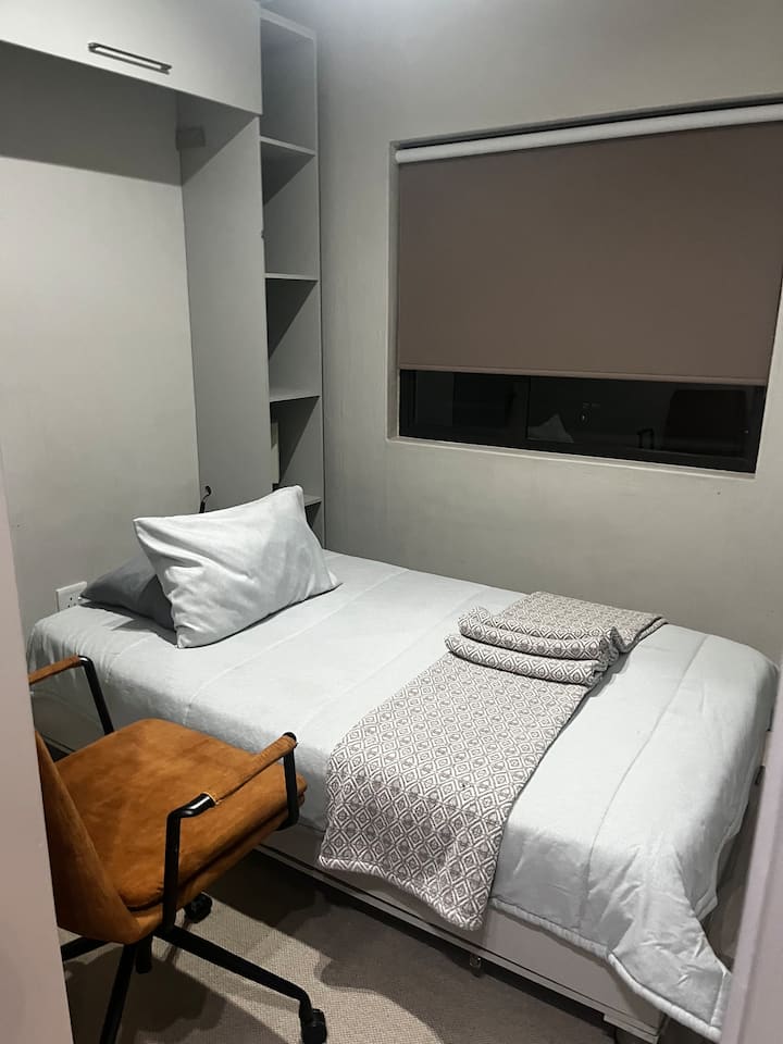 This second bedroom is multipurpose. It has a comfortable pull-down bed that folds up and turns the whole room into a study. The same room also has a plush sleeper couch that can be an additional bed by night.