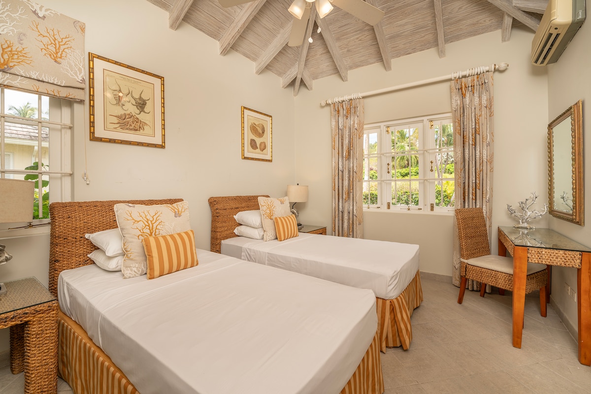 Bedroom 6 has a natural feel, containing twin beds and has an en suite.