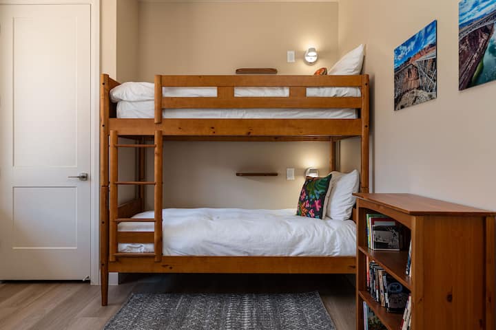 Bunk beds with private lights, shelves, and charging ports.