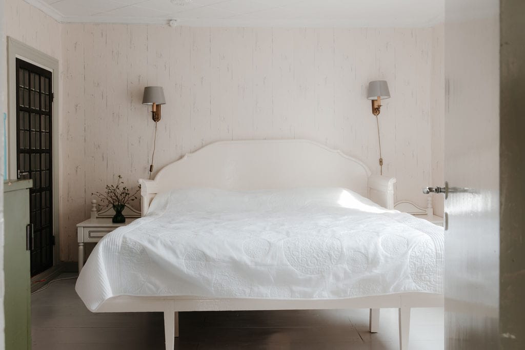 A bedroom with a double bed and a children's bunk bed. There's a fan and a heater in the closet