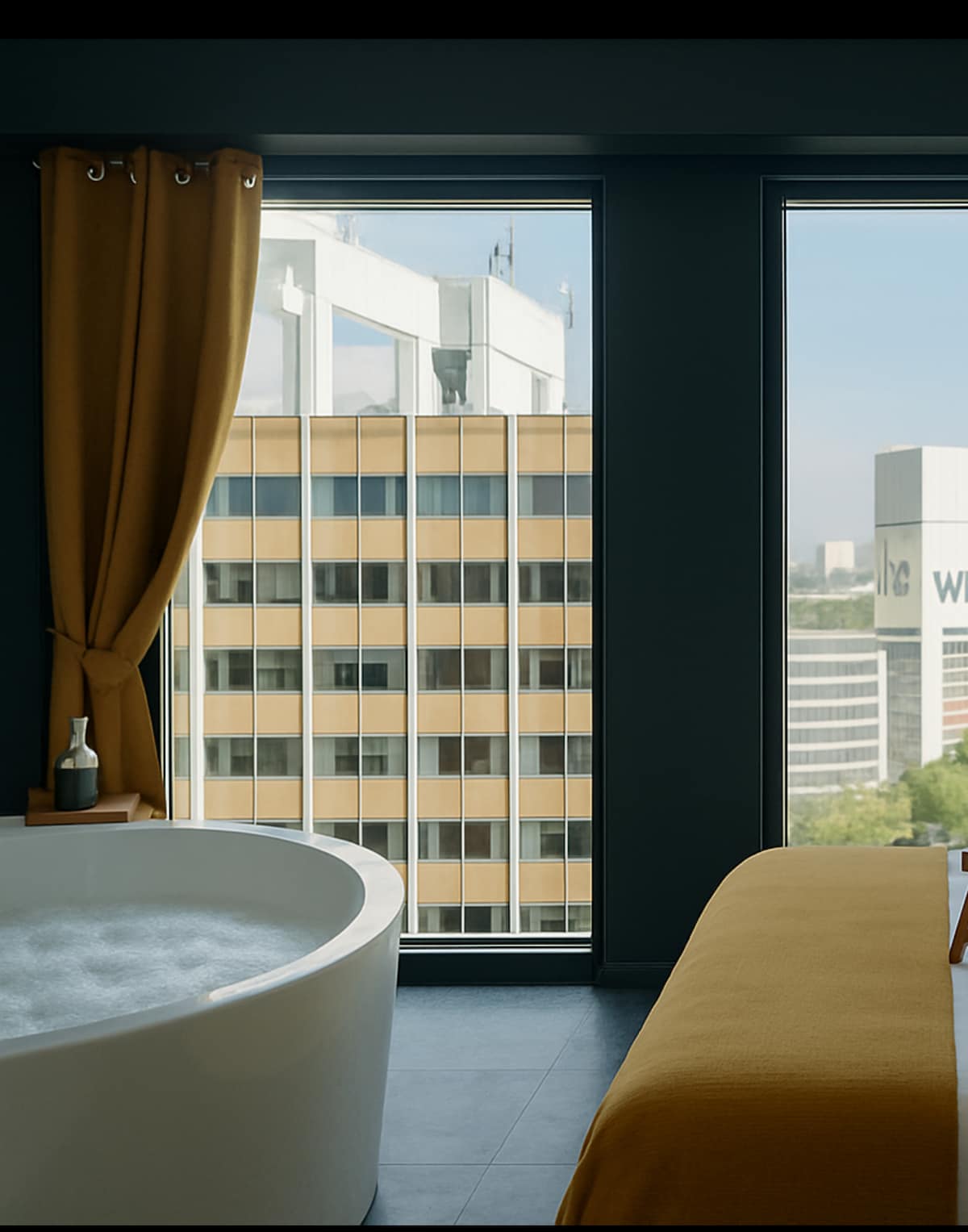 A spacious bathtub is situated near large windows, offering a view of the cityscape. Soft curtains frame the windows, while a cozy bed with a yellow coverlet is positioned nearby. Subtle decor elements add to the modern aesthetic.