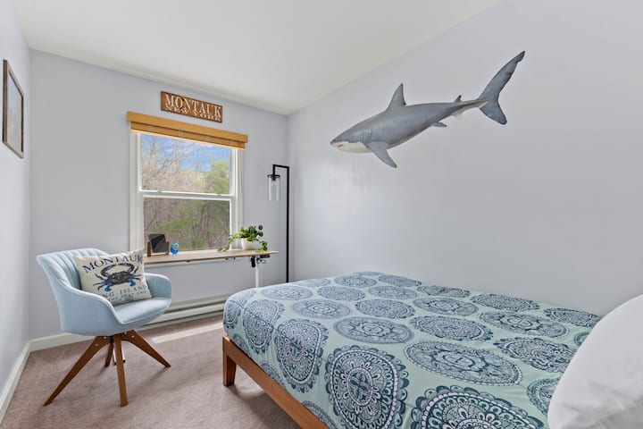 La habitación Montauk cuenta con una cama doble, un escritorio ajustable, un armario grande y un espejo de cuerpo entero, todo con un guiño a LAS MANDÍBULAS: LAS raíces de pesca de tiburones de Montauk.