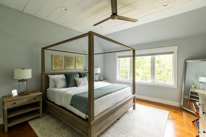 A statement canopy bed and cozy textures set the tone in this spacious primary suite. Enjoy restful sleep and quiet comfort.