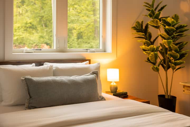 Soft lighting and layered textures create a warm, inviting space to wind down after a day exploring the Hudson Valley.