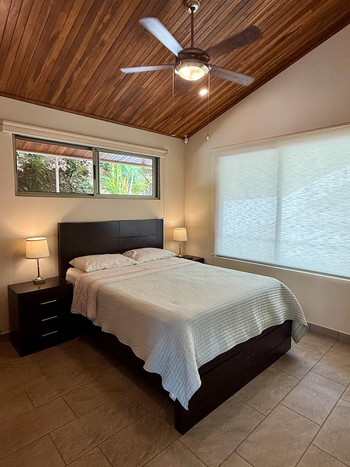 Queen bed, side tables and lamps and ceiling fan. 