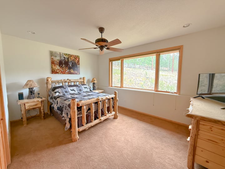 Wake up to natural light and peaceful views from this spacious mountain bedroom.