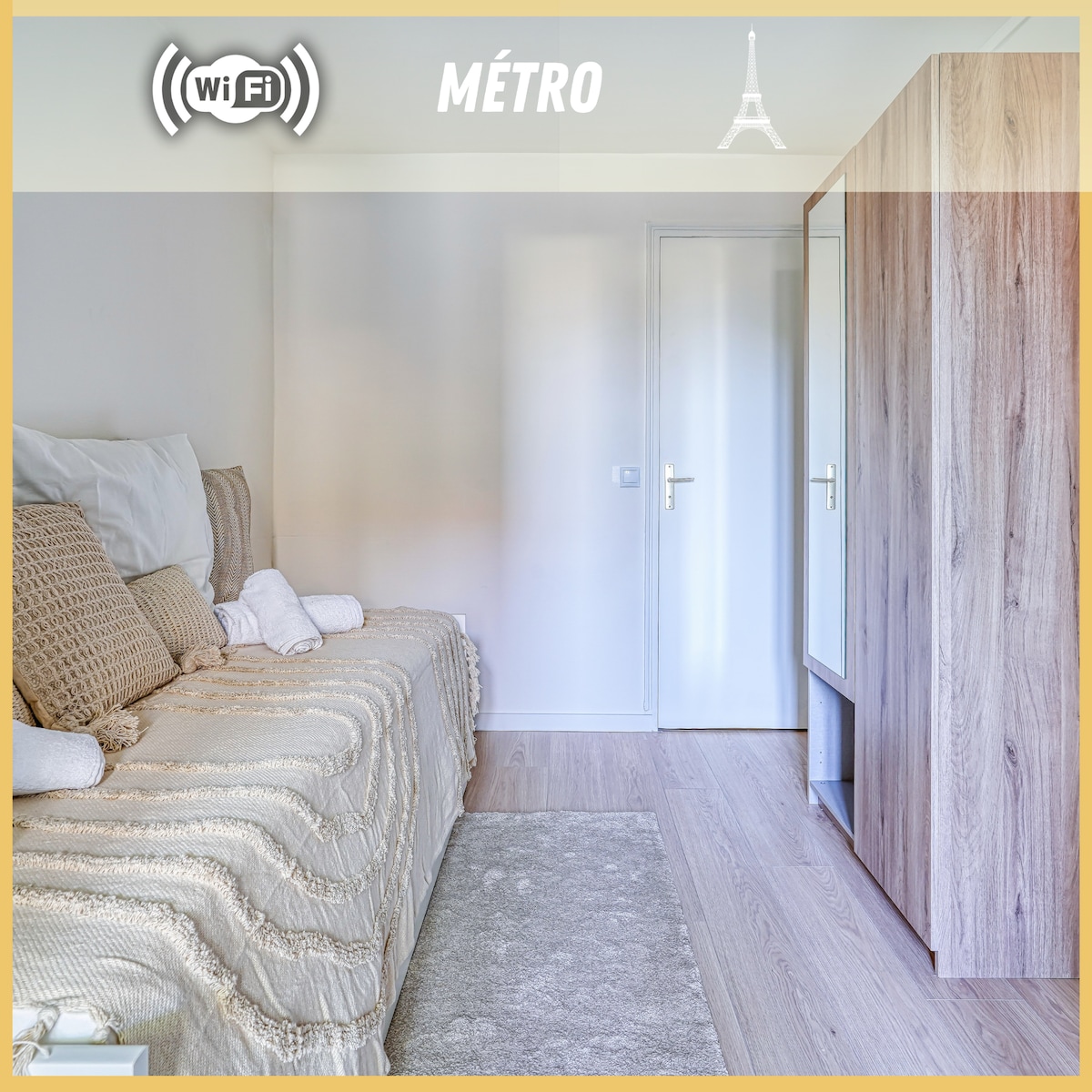 A well-lit living area features a spacious sofa bed draped in an elegant throw. A small rug complements the wooden floor, while a wardrobe stands nearby, offering storage. The neutral color palette creates a calm environment, and the room is enhanced by natural light.