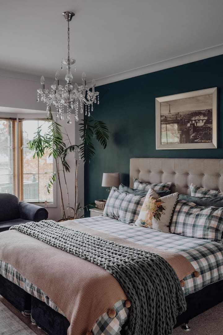 Spacious bedroom with water views and luscious linens.