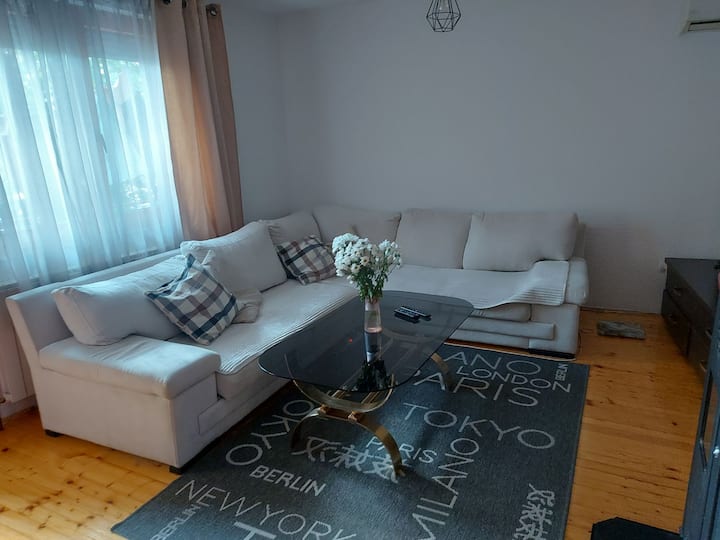 De woonkamer is voorzien van een comfortabele bank die om te bouwen is tot een bed. Het deelt een open ruimte met de keuken, waardoor het een gezellige en praktische ruimte is om te ontspannen, te koken en samen tijd door te brengen.