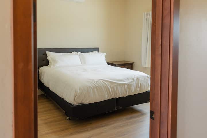 Cozy king-size bed in the front bedroom with hotel-quality linens and extra blankets.