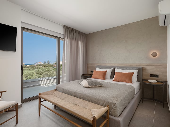 Upper Floor: Bedroom 1 with queen bed, ensuite bathroom, Smart TV,  sea-view balcony