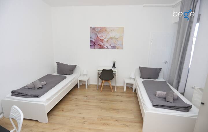 غرفة نوم 2 بسريرين مفردين ومنطقة جلوس وتلفزيون ذكي 