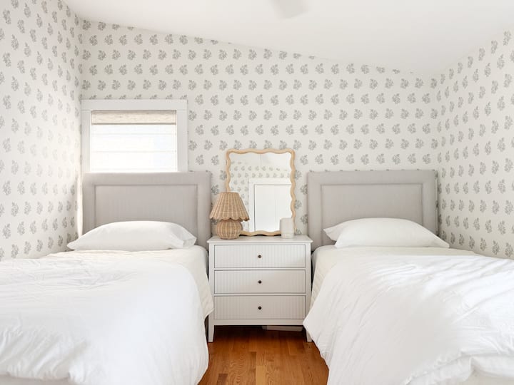 Beautifully designed bedroom on the second floor with two twin XL beds (same length as king so perfect for two adults or kids) with small chest of drawers. Additional clothing storage in closet.