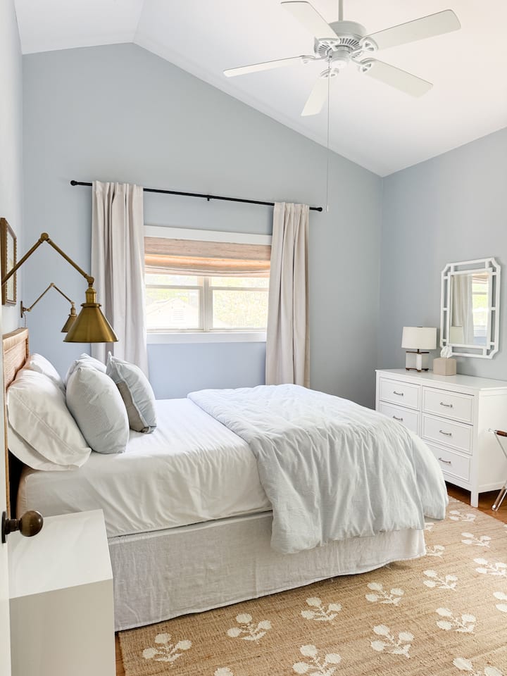 Queen bedroom is located on the first floor, connecting to second family room making it the perfect ensuite for families. Room features luxe bedding, sound machine, and blackout curtains.