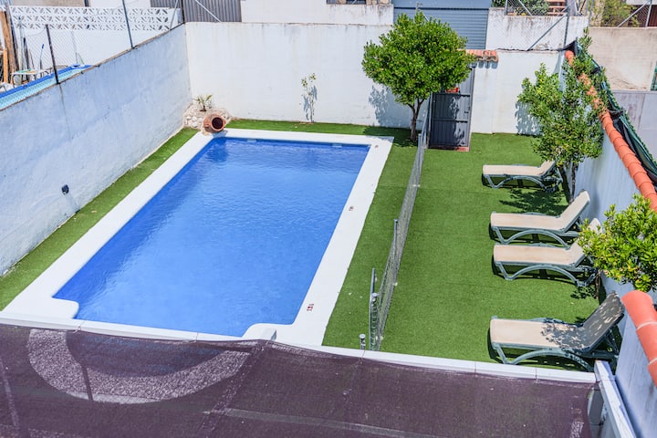Piscina privada con escalera y zona de solárium.